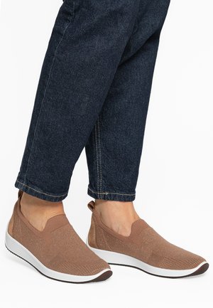 Brown slip-on shoes made of a textured knit material with a white sole and dark brown toe cap, featuring elastic side panels for easy wear.