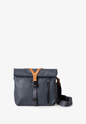 Navy waterproof bag with a roll-top closure, leather strap accents, and a front zip pocket. Features an adjustable shoulder strap.