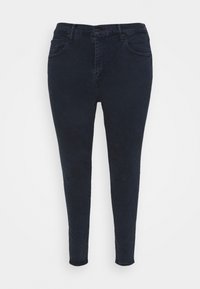 Jeans skinny bleu foncé en denim, présentant un design classique à cinq poches, une fermeture à bouton et une finition lisse légèrement texturée.
