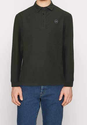 Dark green long-sleeve polo shirt with a button-up collar, featuring a hexagonal logo patch on the chest and a smooth, textured fabric.