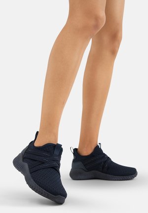Navy blue athletic shoes with a knitted mesh upper, textured sole, and crossed elastic straps for secure fit. Lightweight and breathable design.