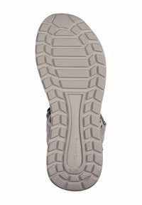 Light gray shoe sole with a textured rubber surface, featuring a geometric tread pattern for traction and stability.