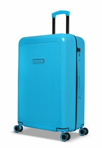 Hard-shell koffer in helderblauw met een geribbelde afwerking. Voorzien van een uitschuifbare handgreep, vier multidirectionele wielen en een ritssluiting.