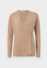 Beige kötött pulóver V-nyakkal, hosszú ujjakkal és bordázott mandzsettával. Puha textúrával és sima felülettel, aszimmetrikus elejével.