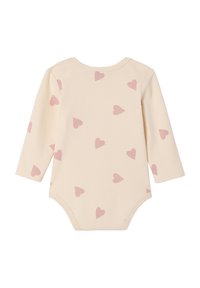 Long-sleeve baby bodysuit in soft beige cotton with a scattered pink heart pattern. Features a round neckline and snap closure.