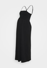 Maksimekkoinen musta äitiysasu, jossa on ryppyjä yläosassa ja säädettävät ohuet olkaimet, yksinkertaisella taustalla.