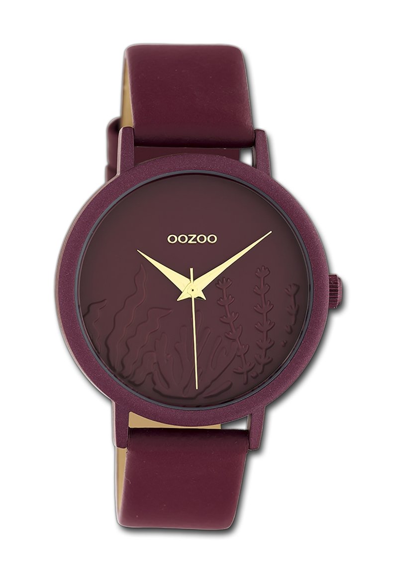 Montre en silicone bordeaux avec un cadran bordeaux texturé présentant des gravures botaniques, des aiguilles des heures et des minutes dorées, et une finition mate.