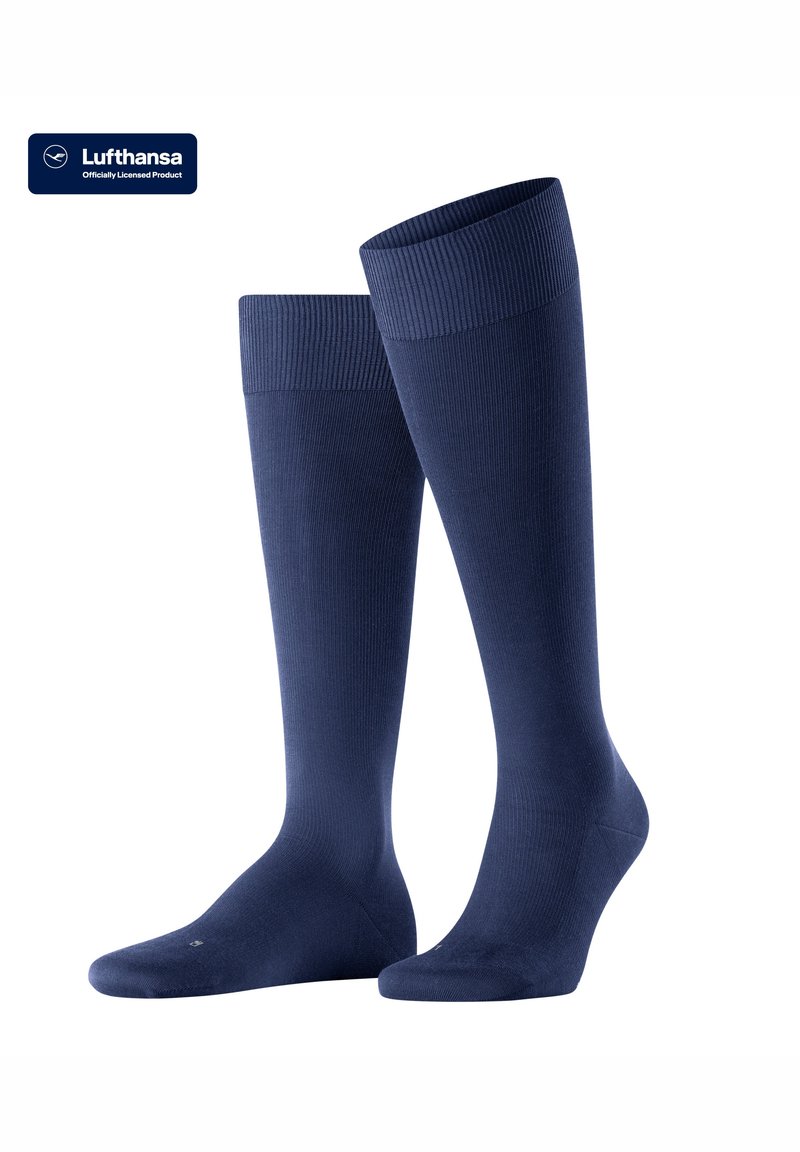 Calze lunghe fino al ginocchio in tessuto blu navy scuro, con un polsino a coste e una superficie liscia, progettate per comfort e supporto durante i viaggi.