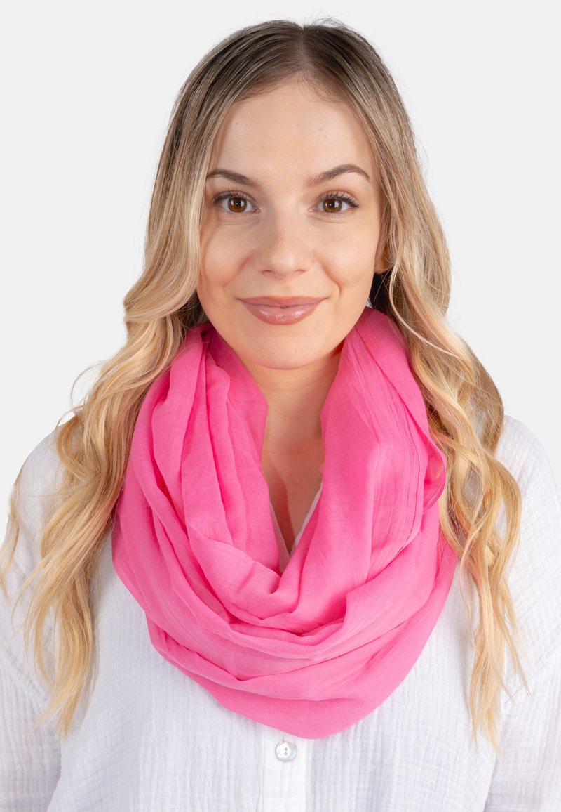 Pink lightweight scarf, draped in layers, made of soft fabric with a slightly crinkled texture, paired with a white button-up shirt.