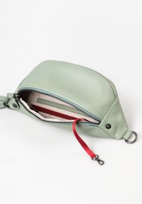 Groene leren tas met een ronde vorm, ritsluiting, rode binnenzak en een rode schouderband. Voorzien van een zilveren clip en een gestructureerde voering.