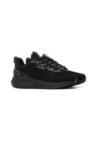 Zapatillas deportivas negras con upper de tejido de punto, diseño texturizado y suela acolchada. Presenta acentos reflectantes y una construcción ligera.