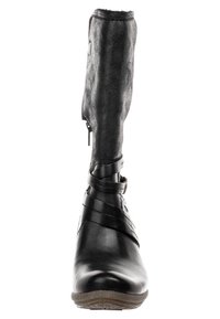 Musta nilkkuri, jossa on sileä nahkainen etuosa, kuvioitu kangasyläosa, sivuvetoketju ja nilkan ympärille kääritty hihnallinen yksityiskohta.