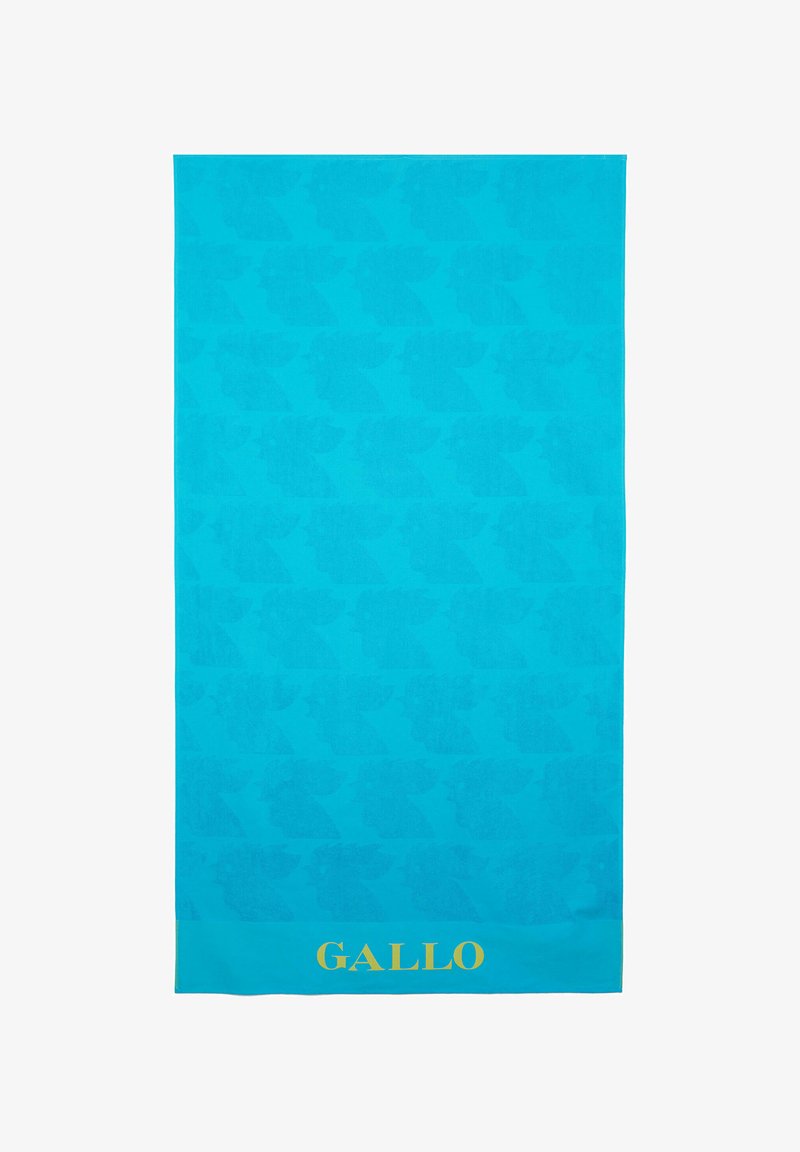 Asciugamano da spiaggia turchese con un motivo ripetuto di silhouette, con un logo dorato "GALLO" sul bordo inferiore. Tessuto morbido e testurizzato.