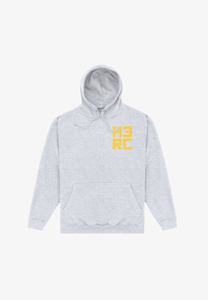 Sweat à capuche gris clair avec poche avant et lettres jaunes en bloc "HERC" sur la partie supérieure gauche de la poitrine, posé à plat sur un fond blanc.