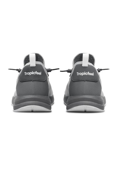 Gray sports shoes feature a mesh upper, elastic laces, and a textured sole. Accents include a white woven pull tab and branding on the heel.