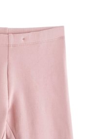 Vaaleanpunaiset legginsit, joissa on pehmeä ja sileä pinta. Niissä on yksinkertainen vyötärö ja minimaalista tikkausta reunoilla.