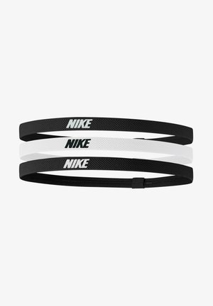 Tre Nike-hårband i svart och vitt. Tillverkade av textil elastiskt material, varje har Nike-logotypen tydligt visad.
