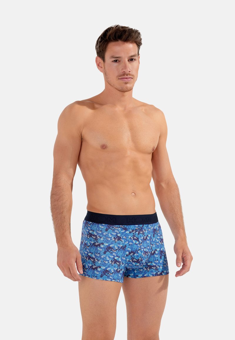 Boxers à motifs blue avec une taille sombre, fabriqués en tissu doux, présentant un design floral de feuilles et de formes abstraites.