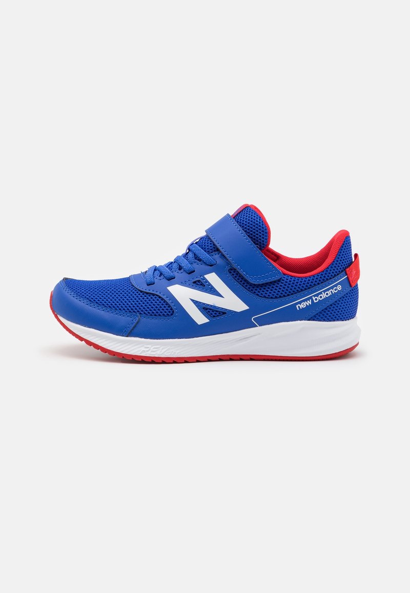 Blue athletic shoe with mesh upper, white logo, red accents, and velcro strap. Features a rubber sole with textured tread for grip.