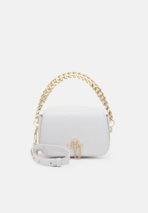 White leather handbag with gold chain handle, adjustable strap, and gold logo clasp on the front flap.