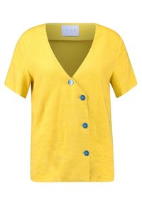 Žlutý krátký rukáv top s výstřihem do V a třemi modrými knoflíky vpředu. Vyroben z texturované látky, s volným střihem.