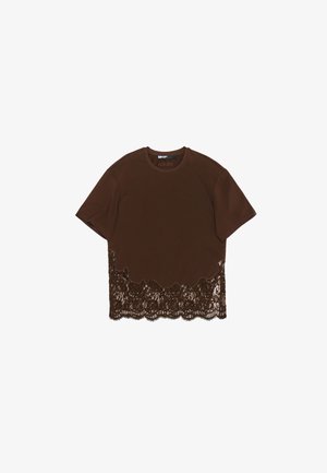 Pruun puuvillane T-särk lühikeste varrukatega, mille ääres on sakiline pits. Pits on tumedamat pruuni värvi, luues kihilise tekstuuri kontrasti.