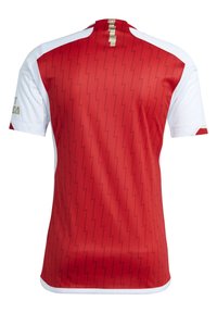 Red sports jersey with white sleeves, featuring a zigzag pattern and gold accents. Back view shows a crew neck design.