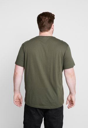 Olive green short-sleeve t-shirt, round neckline, soft fabric, plain design with a slightly curved hem, viewed from the back.