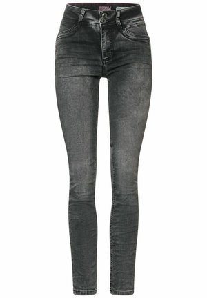 Jeans ajustados en denim negro desgastado, con una cintura alta, cierre de dos botones y diseño clásico de cinco bolsillos. Textura suave con un desgaste sutil.