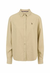 Chemise beige à manches longues boutonnée, avec col, petit détail floral brodé sur la poitrine gauche et ourlet légèrement arrondi.