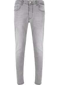Szürke farmernadrág, slim fit szabással, gombos záródással, öt zsebbel, és enyhén kopott részletekkel az anyagon.