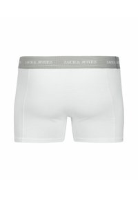 Fehér pamut boxer alsó, szürke elasztikus derékkal, amelyen a "JACK & JONES" logó kontrasztos színnel szerepel. Sima textúra és kényelmes illeszkedés.