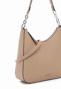 Beige leather shoulder bag with textured surface, curved shape, and black trim. Features a silver zipper and chain-link shoulder strap.