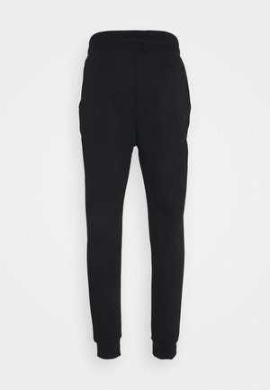 Pantalones de chándal negros ajustados con cintura elástica, tobillos acampanados y un único bolsillo de parche en el lado derecho de la parte trasera.