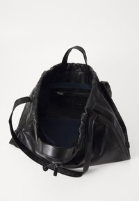Zwarte leren tas met een slungelachtig ontwerp, voorzien van een marineblauwe binnenkant, handvaten aan de bovenkant en een ritsvak aan de binnenzijde. Trekkoord sluiting detail.