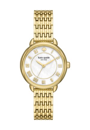 Zegarek Kate Spade w złotym odcieniu z białą tarczą, rzymskimi cyframi, logo pik na 12 oraz bransoletą z ogniw metalowych.