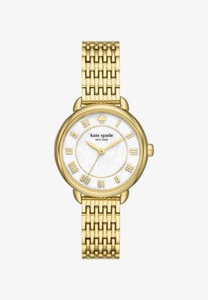 Montre Kate Spade ton or avec cadran blanc, chiffres romains, logo pique à 12 heures et bracelet métallique à maillons.