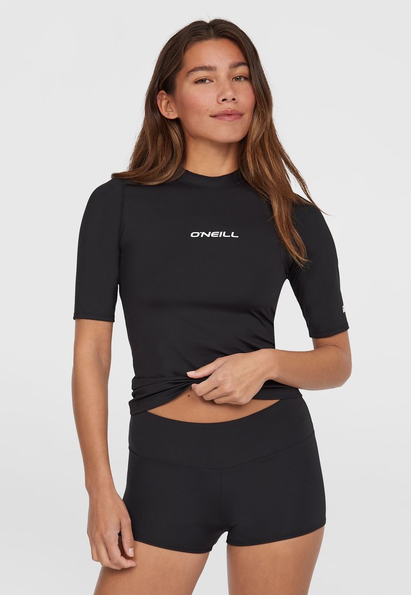 Svart rashguard med korte ermer og O'Neill-logo, laget av elastisk stoff. Kombinert med svarte høyhalsede badeshorts, designet for komfort.