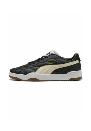 Sorte lædersneakers med en cremefarvet stribe, gummisål og hvide accenter. Har struktureret overflade og snørebåndsdesign.