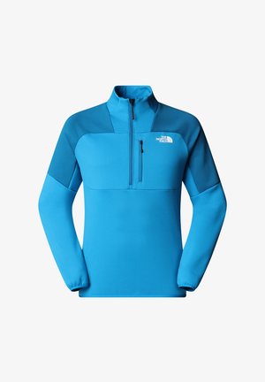 Blauer Fleece-Pullover mit hohem Kragen, halbem Reißverschluss vorne und kontrastierenden, dunkleren Schulterpaneelen. Verfügt über eine Reißverschlusstasche auf der Brust.