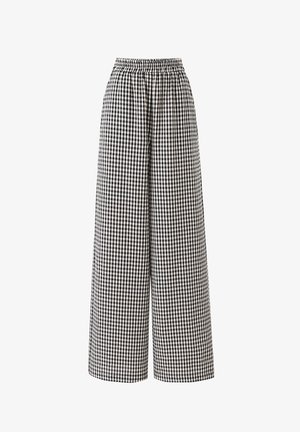 Hoge taille wijde broek met zwart-wit geblokt patroon en elastische tailleband op een witte achtergrond.