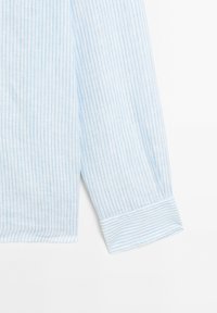Light blue striped long-sleeve shirt with a buttoned cuff, featuring thin white vertical stripes and a soft, textured fabric.