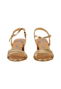 Gold-colored high-heeled sandals with a smooth metallic finish, two slender straps across the toes, and a buckled ankle strap.