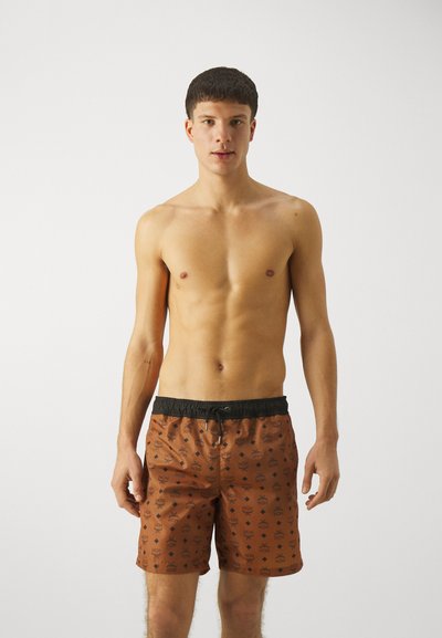 Brown swim shorts with black waistband, featuring a repeating logo pattern. Lightweight material and above-the-knee length design.