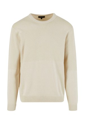 Pull en tricot de couleur crème avec un haut de poitrine et des manches texturés, des poignets et un ourlet à côtes, et un col rond.