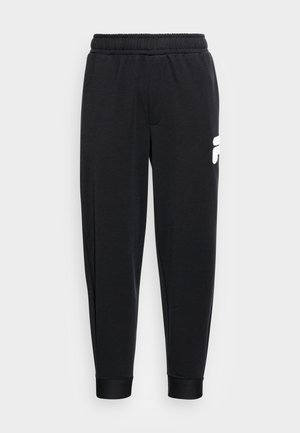 Pantaloni sportivi neri con elastico in vita, caviglie risvoltabili e un accento logo bianco sulla coscia sinistra. Tessuto morbido con una texture liscia.