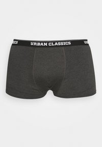 Tmavosivé boxerky s čiernym elastickým pásom, na ktorom je v bielom texte napísané "URBAN CLASSICS", vyrobené z hladkej, elastickej tkaniny.