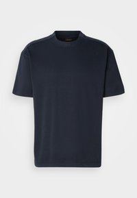 Marinblå bomullst-shirt med rund hals och korta ärmar. Har subtil märkning vid halsen. Slät yta, avslappnad passform.