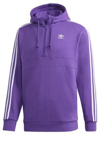 Lila huvtröja med halv dragkedja, med vita ränder längs ärmarna och en adidas-logotyp på bröstet. Mjuk textur.