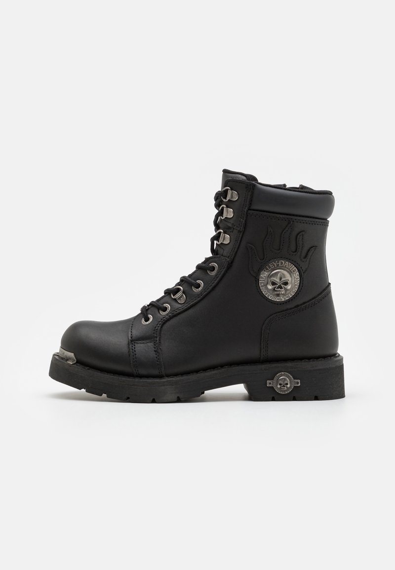 Bottines à lacets en cuir noir avec un design de flammes surélevées, quincaillerie en acier inoxydable et un accent décoratif en métal en forme de crâne sur le talon.